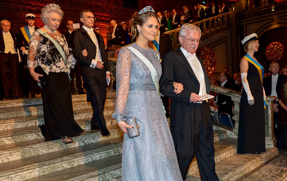 Sweden's Princess Madeleine and Chemistry Laureate Paul Modrich arrive at he Blue Hall for the 2015 Nobel prize award banquet, in Stockholm City Hall.