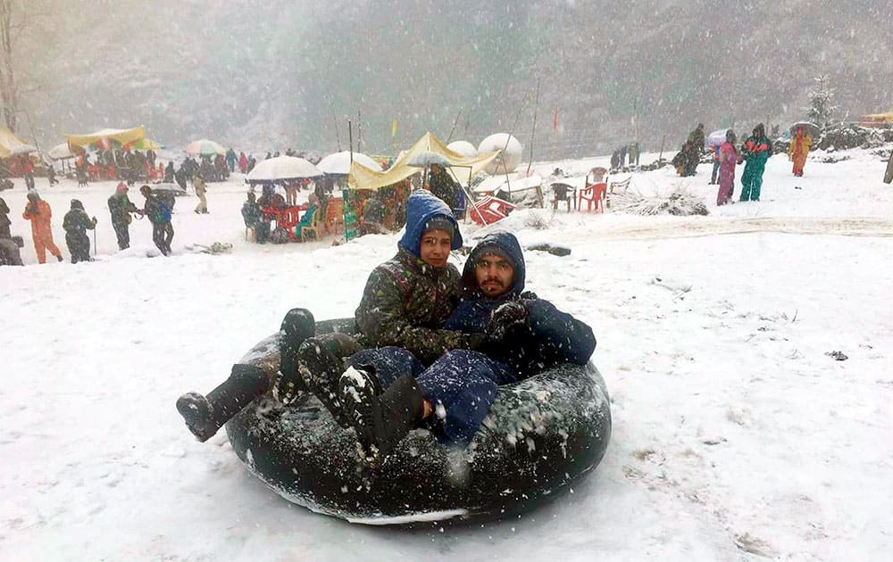 Tourists enjoying snow at Manali in Himachal Pradesh