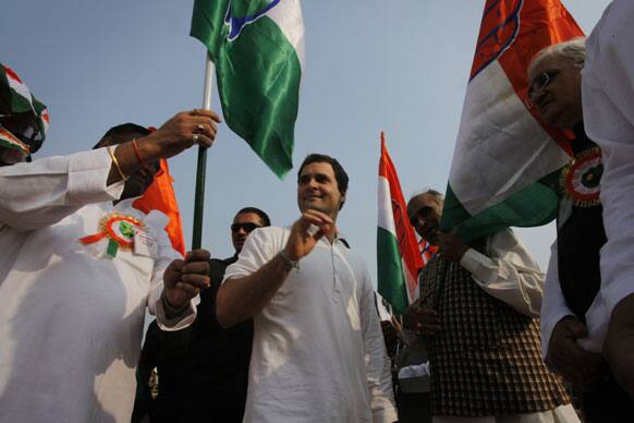 India`s ruling Congress party leader Rahul Gandhi, center, hands over party flags to other leaders at a public rally at Jhunsi in Allahabad, India.