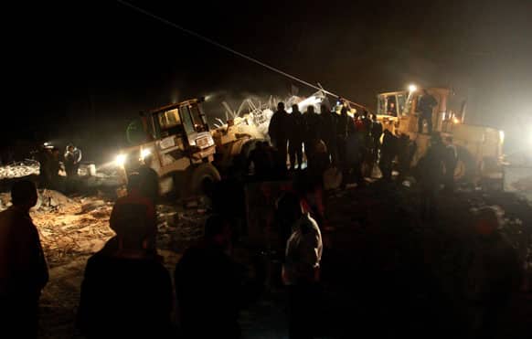 Palestinians inspect the damage at a Hamas training camp following an Israeli airstrike in Beit Lahia, northern Gaza Strip.