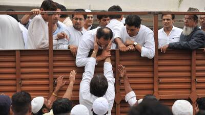 Mourners offer condolences to former Indian cricket captain and Moradabad Member of Parliament Mohammad Azharuddin on board a truck during a funeral procession for his son Mohammed Ayazuddin in Hyderabad.