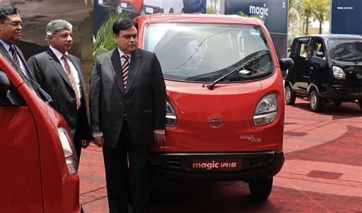 Standing left to right are, Anil K. Kapur, Head-Sales and Marketing, LCVs and SCVs of Tata Motors Ltd, Ravi Pisharody, President - Commercial (CVBU) of Tata Motors Ltd and Sandeep Kumar, Head - Sales, Commercial Vehicle of Tata Motors Ltd during the launch of the Tata Magic Iris, seen on display, in Mumbai.