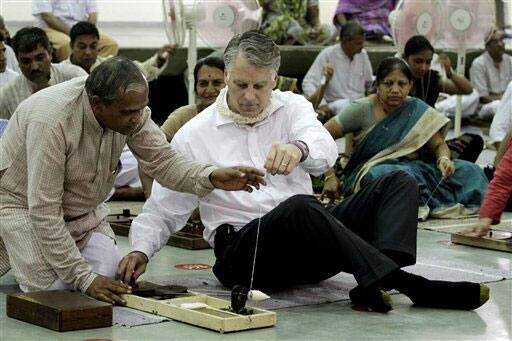 U.S. Ambassador to India Timothy J. Roemer, tries his hand on a spinning wheel at Gujarat Vidyapith, an educational institution founded by Mahatma Gandhi in 1920, in Ahmadabad.