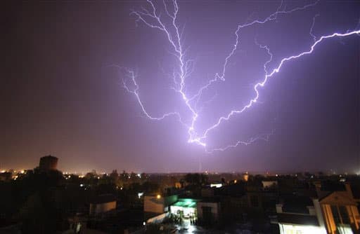 A bolt of lightning strikes in the horizon over Jammu, India during a summer storm.