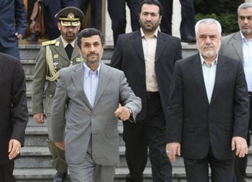 Iranian President Mahmoud Ahmadinejad, makes his way during a departure ceremony for him as he leaves the country for Turkey to attend an international conference, as Vice President Mohammad Reza Rahimi and advisor to the supreme leader, Ali Akbar Velayati, walk at the Mehrabad airport in Tehran.