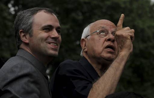 Indian Minister of New and Renewable Energy Farooq Abdullah, gestures as his son and Jammu Kashmir state CM Omar Abdullah looks on during the inauguration of the Mughal Gardens in Srinagar.