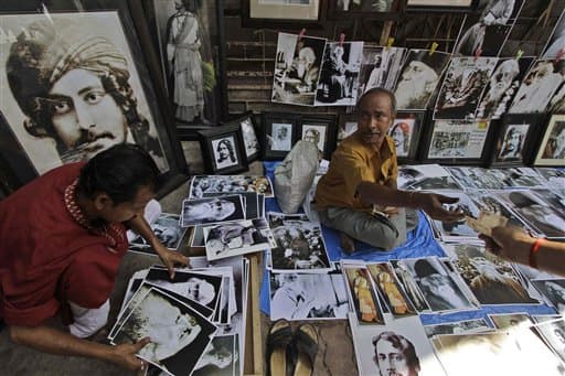 A customer goes through photographs of Nobel laureate Rabindranath Tagore at a roadside vendor selling memorabilia of Tagore and others, during the 150th birth anniversary celebrations of the Indian poet near his residence in Kolkata.