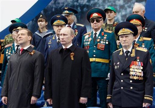 Russian President Dmitry Medvedev, left, and Prime Minister Vladimir Putin, center, seen during the Victory Day parade, in Moscow.