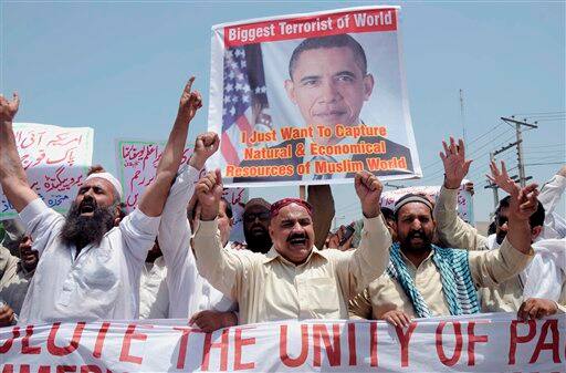 Activists of a local social group Muthahida Shehri Mahaz hold up a banner depicting U.S. President Barack Obama, during a rally to condemn the killing of al-Qaida leader Osama bin Laden, in Multan.