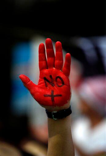 A demonstrator, his hand painted in red with the word `No`, to read in Spanish: `No More Violence`, protests during a march against gang violence in Mexico.