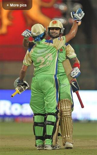 Royal Challengers Bangalore`s Tillakaratne Dilshan and Virat Kohli celebrate their team`s victory over Kochi Tuskers Kerala wicket during an IPL cricket match in Bangalore.