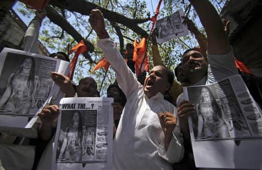 Hindu activists carry photographs of a model in a swimsuit and shout slogans against the Australian government in Jammu.