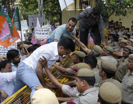 Members of the youth wing of India`s main opposition Party (BJP) attempt to climb over barricades during a protest. Dozens of BJP members protested against India`s ruling Congress party in delaying to hang Mohammed Ajmal Kasab.