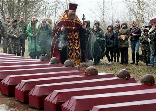 An Orthodox priest conducts a funeral ceremony for remains of Soviet soldiers killed during World War II, at a memorial cemetery at the village of Sinyavino, 50 km (31 miles) east of St.Petersburg, Russia. The remains of over 500 soldiers killed in heavy battles during World War II near Leningrad, now St. Petersburg, in 1942-1944, were buried during a ceremony in Sinyavino on the eve of Victory Day, celebrated in Russia on May 9.