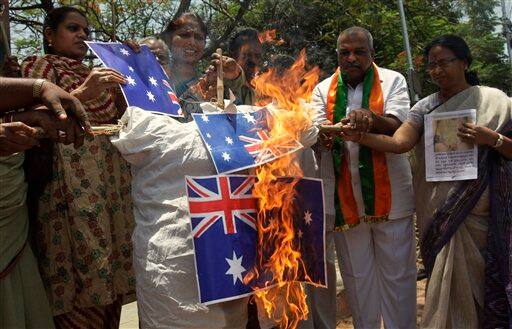 Activists of India`s Bharatiya Janata Party (BJP) burn Australian flags and an effigy in Hyderabad as they protest against Australian fashion designer Lisa Blue`s swimwear creations that featured images of Hindu goddess Lakshmi at the Australian Fashion Week.