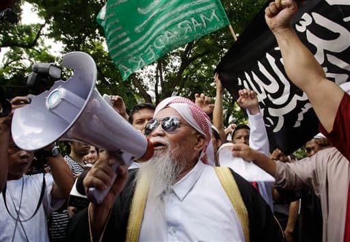 Spiritual leader Alim Jamil Yahya addresses a crowd of Filipino Muslims during a rally near the U.S. Embassy in Manila. Filipino Muslims condemned the killing of Osama bin Laden and the bombing of Libya while accusing the United States of terrorism. 