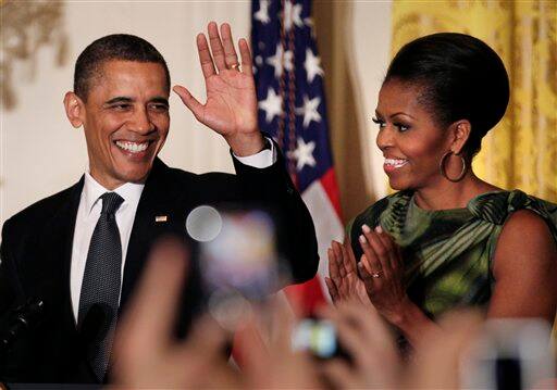 President Barack Obama waves to guests as he and first lady Michelle Obama host a Cinco de Mayo reception at the White House.