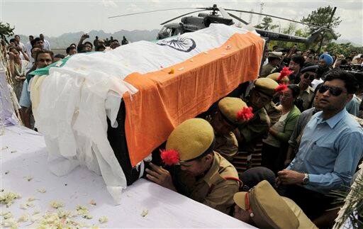 The body of India`s northeastern Arunachal Pradesh state Chief Minister, Dorjee Khandu, is brought for people to pay last respects at Itanagar. Khandu died after a single-engine helicopter carrying him and four others crashed Saturday in a densely forested area in the Himalayan foothills.