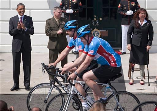 President Barack Obama and Joint Chiefs Vice Chairman Gen James Cartwright and Assistant Veteran Affairs Secretary Tammy Duckworth, cheer on riders during an event to welcome the Wounded Warrior Project`s soldier ride to the White House in Washington.