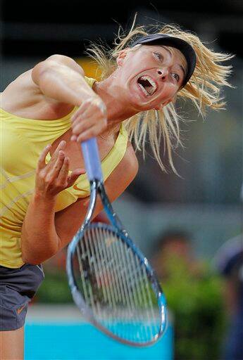 Maria Sharapova serves during the match against Dominika Cibulkova in the Madrid Open tennis tournament.