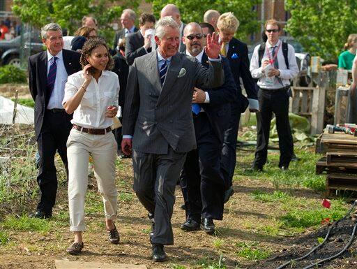 Britain`s Prince Charles waves during a tour of the Common Good City Farm on Capitol Hill in Washington.