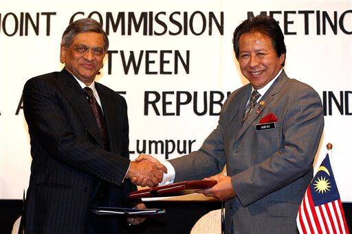 India`s Minister of External Affairs S.M. Krishna exchange memorandum with Malaysia`s Foreign Minister Anifah Aman during the fifth session of the Malaysia-India Joint Commission Meeting in Kuala Lumpur.