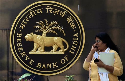 A reporter speaks on a mobile phone at the head office of India`s central bank, the Reserve bank of India, in Mumbai. India`s central bank raised its key interest rate by half a percentage point Tuesday, its ninth hike in just over a year, warning that persistent inflation has become a threat to growth in Asia`s third-largest economy.