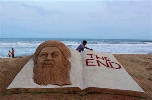 Indian sand artist Sudarshan Pattnaik gives finishing touches to a sand sculpture to mark the killing of Osama bin Laden at the golden sea beach at Puri, Orissa.