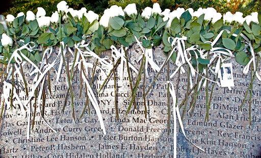 White roses lay on names etched in stone in Boston Monday, May 2, 2011 at the Garden of Remembrance, a memorial dedicated to the 206 Massachusetts victims of September 11, 2001. A memorial event was held in the wake of news of the death of Osama bin Laden.