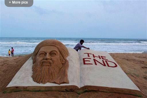 Indian sand artist Sudarshan Pattnaik gives finishing touches to a sand sculpture to mark the killing of Osama bin Laden at the golden sea beach at Puri, Orissa.