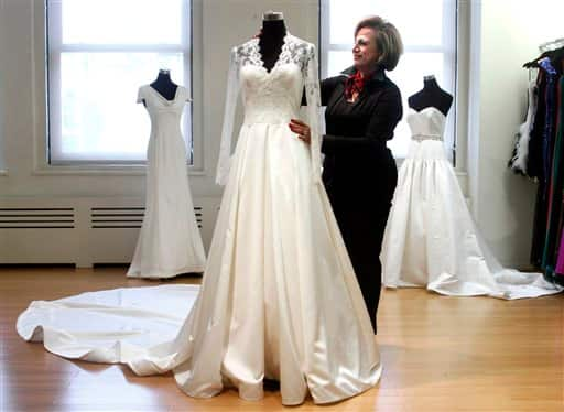 Shala Moradi, lead designer at Faviana fashion house, positions a finished copy of the royal wedding gown worn by Kate Middleton in New York. 