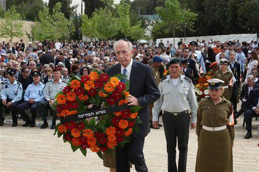 Israeli President Shimon Peres lays a wreath during the annual ceremony for Holocaust Remembrance Day at the Yad Vashem memorial in Jerusalem. The state of Israel marks the annual Memorial Day commemorating the six million Jews murdered by the Nazis in the Holocaust during World War II.