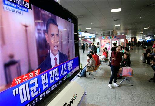 People watch a live TV reporting of U.S. President Barack Obama`s speech about Osama bin Laden, at Seoul train station in Seoul.