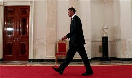 President Barack Obama walks down the Cross Hall on the way to the East Room to make a televised statement on the death of Osama bin Laden from the White House in Washington.