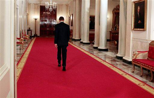 President Barack Obama walks back down the Cross Hall after making a televised statement on the death of Osama bin Laden from the East Room of the White House in Washington.