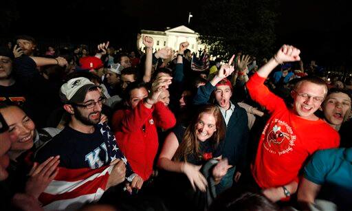 A crowd outside the White House in Washington, cheers Sunday, May 1, 2011, upon hearing the news that terrorist leader Osama bin Laden is dead.