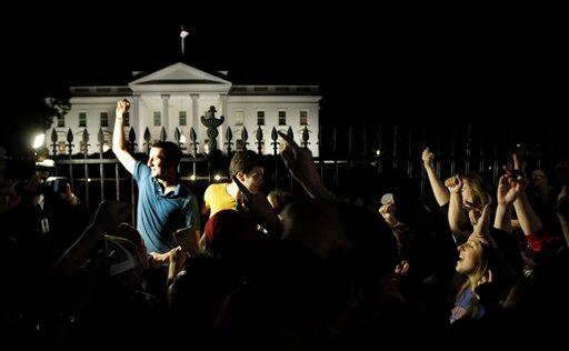 A crowd outside the White House in Washington, cheers Sunday, May 1, 2011, upon hearing the news that terrorist leader Osama bin Laden is dead.