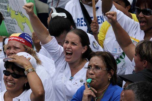 Opponents of Venezuela`s president Hugo Chavez shout slogans during a May Day rally in Caracas, Venezuela.