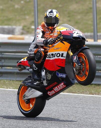 MotoGP rider Dani Pedrosa, from Spain, lifts the wheel of his Honda after winning the Portugal motorcycling Grand Prix.