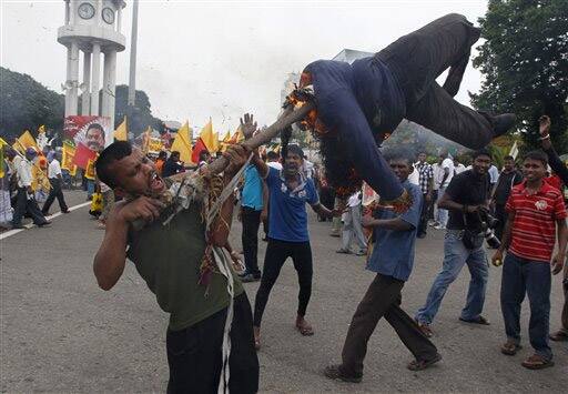 A supporter of the Sri Lanka`s ruling party United People`s Freedom Alliance, burns an effigy of UN Secretary General Ban Ki-moon in Colombo.