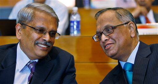 Infosys Technologies Ltd. Chairman N.R. Naryana Murthy, right, talks to Chief Operating Officer S. Gopalakrishnan after announcing management changes of the company at their headquarters in Bangalore.