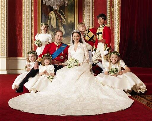 Britain`s Prince William, center left, and his wife Kate, Duchess of Cambridge, center right, pose for a photograph with, clockwise from bottom right, Margarita Armstrong-Jones, Eliza Lopes, Grace van Cutsem, Lady Louise Windsor, Tom Pettifer, and William Lowther-Pinkerton in the Throne Room at Buckingham Palace, following their wedding at Westminster Abbey, London.