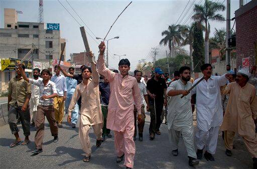 Angry Pakistani Muslims hold bamboo sticks and chant slogans during a rally against alleged an burning of the Muslim holy book the Quran, in Gujranwala, Pakistan on Saturday, April 30, 2011. Officials say police have broken up an angry mob threatening to burn a church after the alleged burning of a Quran in eastern Pakistan.