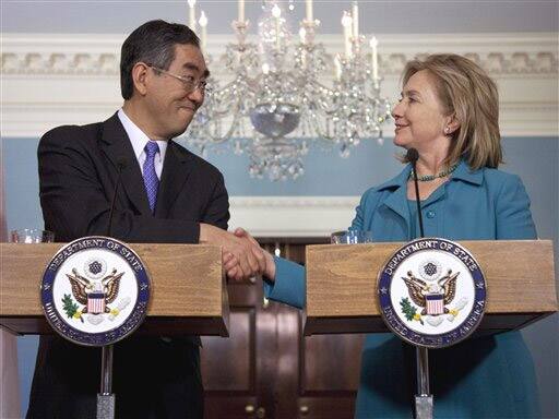 Secretary of State Hillary Clinton shakes hands with Japanese Foreign Minister Takeaki Matsumoto at the State Department in Washington. 