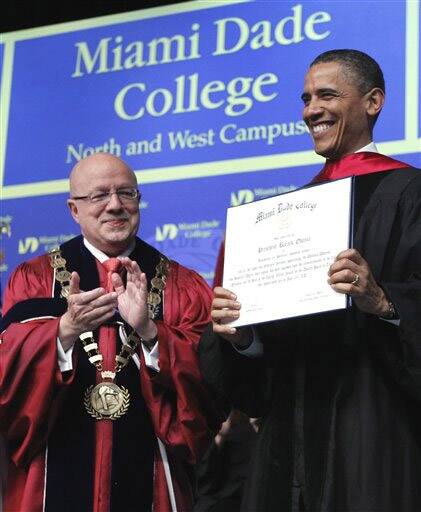 President Barack Obama receives an honorary associates degree during the Miami Dade College Nrth and West Campus graduation.