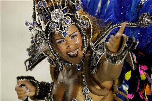 A Portela samba school dancer performs during a Carnival parade through the Sambadrome in Rio de Janeiro, Brazil.