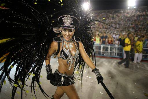 A Sao Clemente samba school dancer marches in a carnival parade at the Sambadrome in Rio de Janeiro, Brazil.