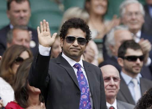 Indian cricketer Sachin Tendulkar waves as he arrives on Centre Court for the match between Serena Williams of the U.S. and Dominika Cibulkova of the Czech Republic at the 2010 Wimbledon tennis championships in London, June 26, 2010.