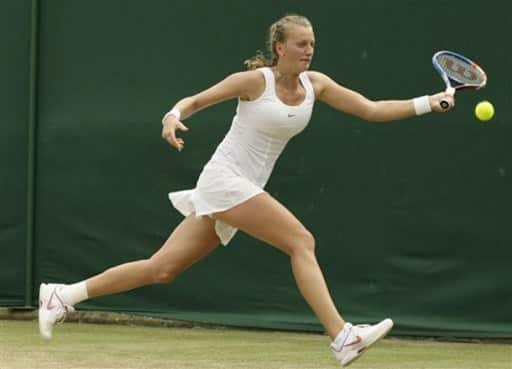 Petra Kvitova of the Czech Republic returns to Victoria Azarenka of Belarus during their women`s singles match at the All England Lawn Tennis Championships at Wimbledon, Saturday, June 26, 2010.