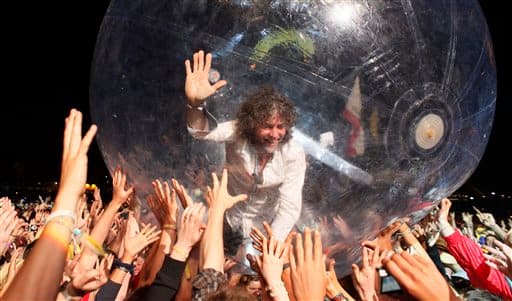 U.S. band The Flaming Lips, frontman Wayne Coyne takes a trip across the heads of the crowd inside a plastic bubble, as the band performs at Glastonbury Festival, in Glastonbury, England, Friday, June 25, 2010. The Festival celebrates its 40th anniversary this year.